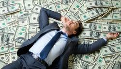 businessman lying on a pile of money-2